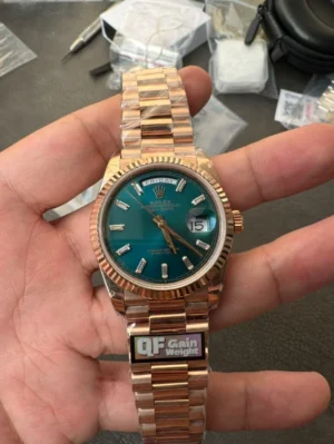 QF Rolex Day-Date 36mm QF Rolex Day-Date 36mm Super Clone with a President bracelet and classic day and date display.