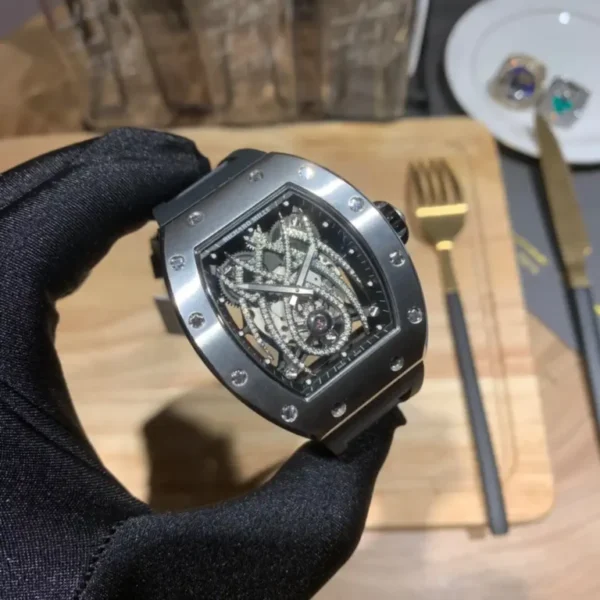 Richard Mille RM 19 Replica Watch Richard Mille RM 19 replica watch with a skeletonized dial, tonneau-shaped case, mechanical movement, sapphire crystal, and black rubber strap.