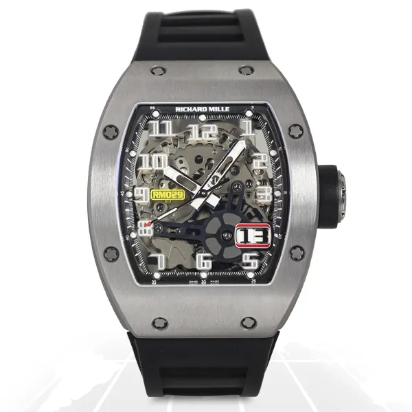 Richard Mille RM029 Oversize Date RM029 AK TI luxury replica watch with a titanium-style tonneau case, skeleton dial, oversized date display, and black rubber strap.