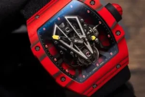 Richard Mille RM27-03 Tourbillon Rafael Nadal Red Carbon 44mm watch with a skeletonized dial, red carbon tonneau case, manual-winding movement, and black rubber strap.