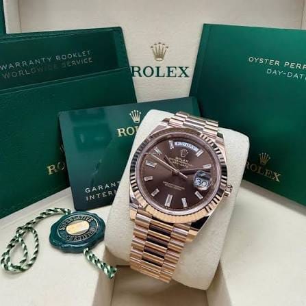 Rolex Day-Date 40mm Full Set with a President bracelet, day and date display, and complete presentation box and accessories.