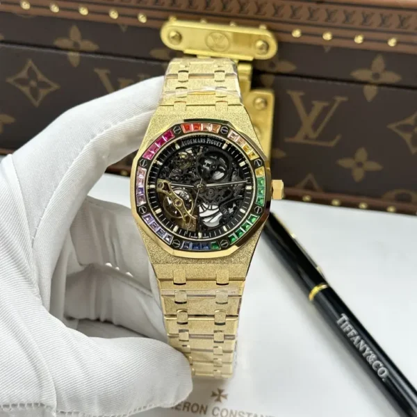 Audemars Piguet Royal Oak Openworked 15412 with a Yellow Gold frosted case, Skeleton Dial, Baguette Stone Bezel, and 41mm case.