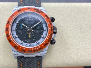 Daytona DIW White Carbon Orange Bezel N6F 1:1 Best Edition featuring a Black and White Dial, white carbon case, orange-accented carbon bezel, gray nylon strap, and SA4130 automatic chronograph movement.