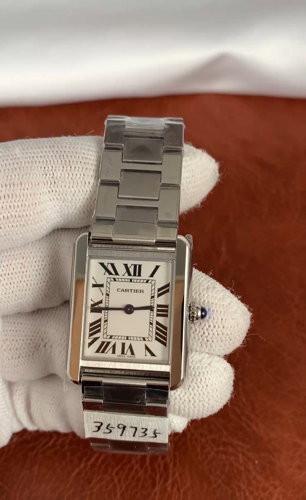 Cartier Tank W5200013 2 Cartier Tank Solo 31mm men's watch with white Roman numeral dial, rectangular stainless steel case, and matching steel bracelet